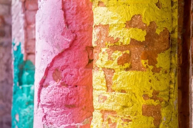 A detailed shot of an old brick wall, part of which is covered with vibrant, well-preserved graffiti, illustrating different textures and colors under natural light.
