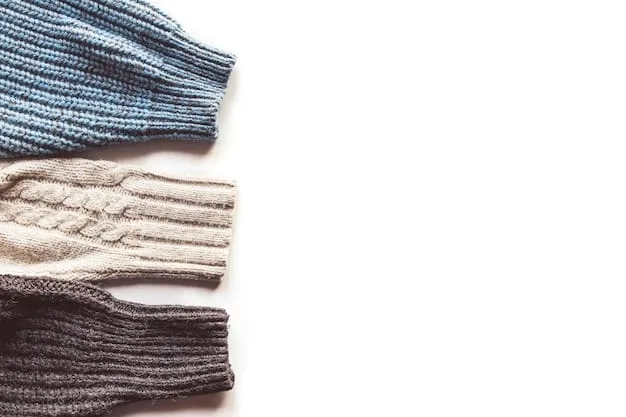 A detailed flat lay of various streetwear garments for layering, demonstrating different textures and lengths, including a graphic tee, an open plaid flannel, a denim jacket, and a beanie, all in complementary muted tones, arranged neatly.