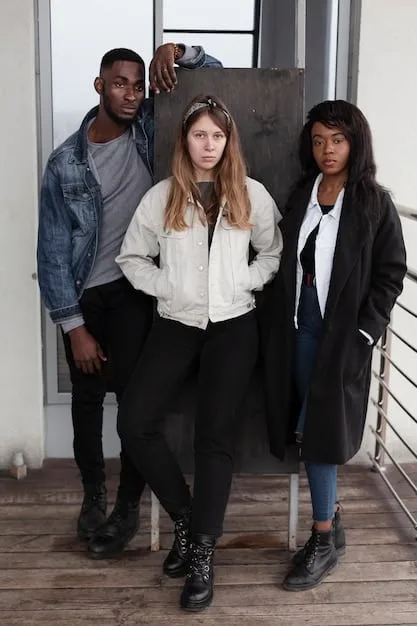 A diverse group of non-binary models wearing gender-neutral streetwear from a forward-thinking brand, showcasing harmonious, oversized, and comfortable clothing in a studio setting.