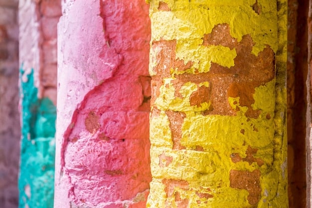 A detailed shot of an old brick wall, part of which is covered with vibrant, well-preserved graffiti, illustrating different textures and colors under natural light.