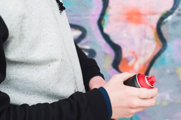A detailed shot of an art collector examining a graffiti piece in a modern, minimalist home, emphasizing the integration of urban art into sophisticated private collections and the careful consideration involved in acquiring such assets.