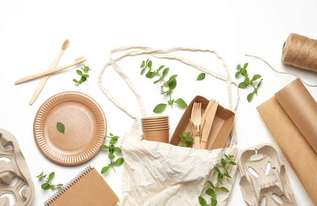 A detailed flat lay of various sustainable and ethically produced merchandise items, possibly made from organic cotton or recycled materials, with a tag indicating ethical sourcing. There's a subtle artistic flair, perhaps a sketch of a design concept or a mood board.