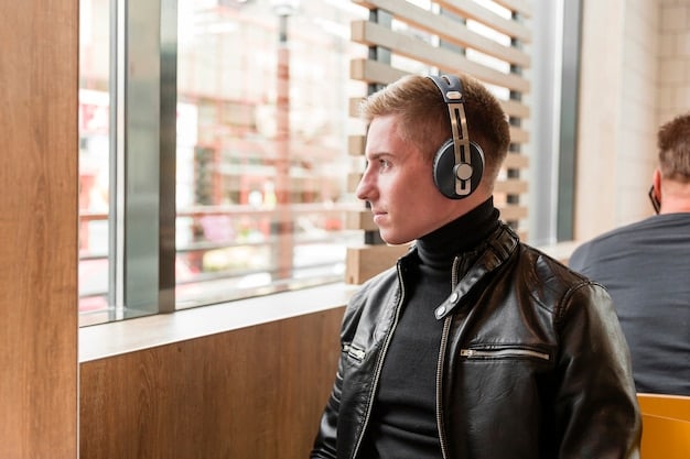 A close-up, contemplative portrait of a musician in a recording studio, with headphones around their neck, reflecting on their thoughts, symbolizing the introspective nature of creating music that addresses mental health.