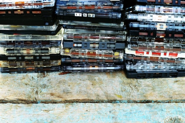 A stack of old hip hop cassette tapes with hand-drawn labels, next to an open CD jewel case featuring a classic hip hop album cover, illustrating the physical formats of music from the 80s and 90s.