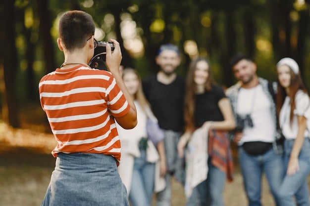 A behind-the-scenes photo showing a small crew of young filmmakers using smartphone cameras and basic lighting equipment to film an emerging rapper in a local park.