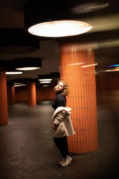 An emerging rapper standing confidently in front of a brick building, illuminated by the soft glow of affordable LED panel lights, showcasing how effective simple lighting can be.