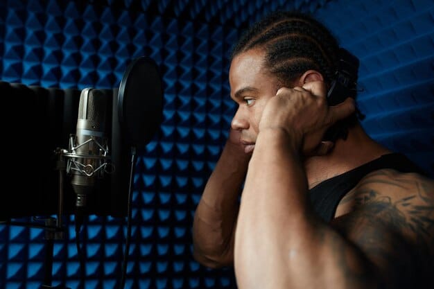 A close-up of a US rap artist in a recording studio, focused and passionate. The studio setting is dimly lit with modern recording equipment, conveying a sense of creativity and hard work. The artist's expression is intense, showing dedication to their craft.