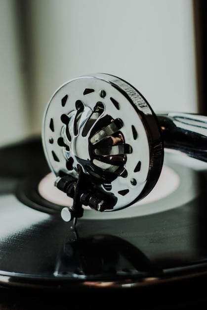 A close-up shot of a vinyl record spinning on a turntable, with a microphone and headphones in the background. The image evokes a sense of musical creation and the recording process.