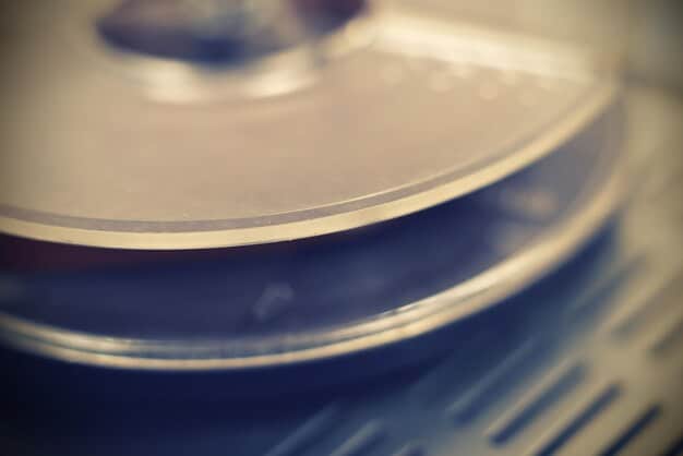 A close-up of a vinyl record spinning on a turntable, symbolizing the physical distribution of music for independent labels. The background is blurred, focusing attention on the record itself.