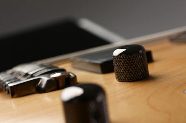 A close-up shot of a budget-friendly condenser microphone on a desk stand, with a pop filter in front of it. In the background, there's an audio interface connected to a laptop, highlighting the basic equipment of a home recording studio.