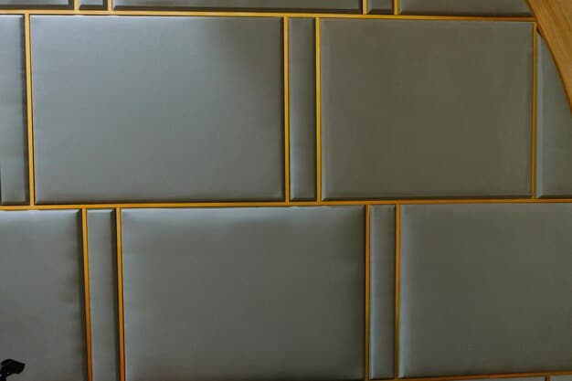 Several DIY acoustic panels made from wood frames wrapped in fabric, mounted on the wall of a home studio. The panels are arranged in a pattern to absorb sound reflections and improve the room's acoustics.