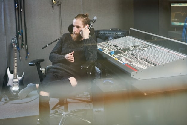 An acoustic engineer using computer and audio software for advanced reverb processing in a sound studio. The lighting is focused on the computer screen and mixing desk with other studio equipment blurred in the background.