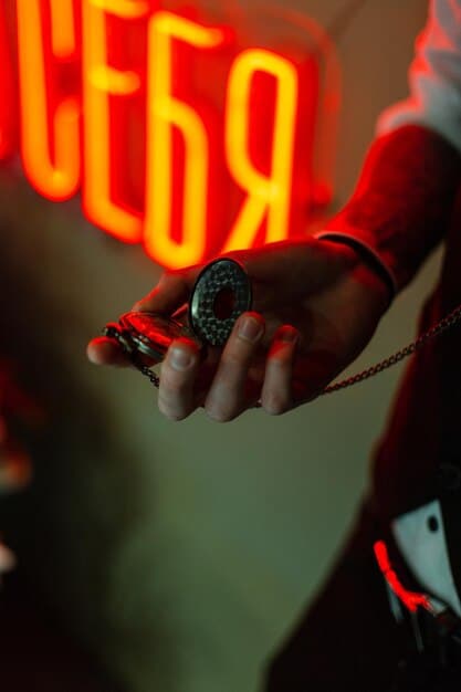 A close-up of a rapper's hand holding a microphone during a live performance. The focus is on the hand and microphone, with a blurred background of the crowd and stage lights. The image captures the intensity and passion of a live rap performance.