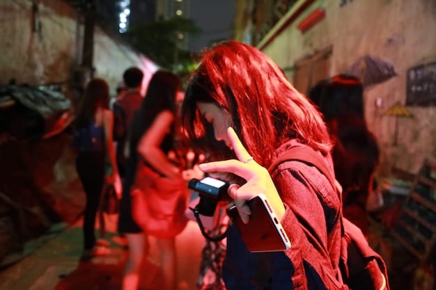 A candid shot of fans interacting with artists after a performance at an underground rap festival, capturing the personal connection and excitement.