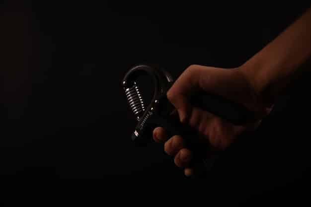 A close-up of hands holding a microphone in a dimly lit studio, with blurry faces in the background, symbolizing the creative expression but also the potential isolation and mental health challenges of underground rappers.