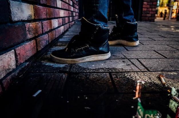 A close-up shot of stylish streetwear sneakers on a paved urban ground, highlighting their bulk and textured details, with the cuff of a well-fitted cargo pant visible just above the shoe, demonstrating a perfect break.