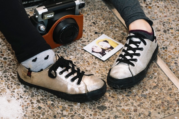 A detailed close-up shot focusing on a pair of rare, limited-edition streetwear sneakers, emphasizing texture and design against a blurred urban background.