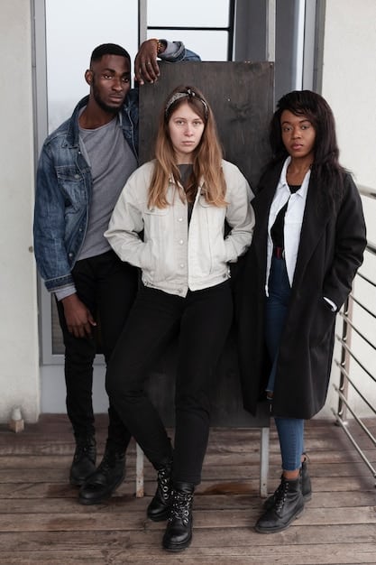 A diverse group of non-binary models wearing gender-neutral streetwear from a forward-thinking brand, showcasing harmonious, oversized, and comfortable clothing in a studio setting.