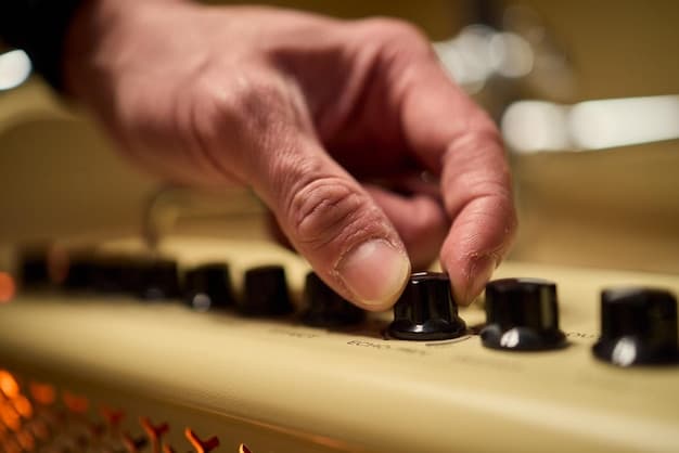 A close-up of a musician's hand adjusting a knob on an analog synthesizer, with sheet music and a laptop displaying streaming analytics in the background, symbolizing the blend of traditional artistry and digital distribution challenges.