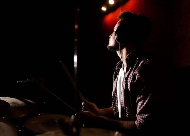 A musician taking a deep breath and focusing backstage, surrounded by dim lights and instruments, conveying calmness before a performance.