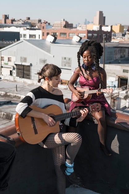 A group of young, diverse musicians setting up a DIY stage in an urban alleyway, with string lights and repurposed materials, preparing to film a music video. The scene highlights collaboration and resourcefulness.