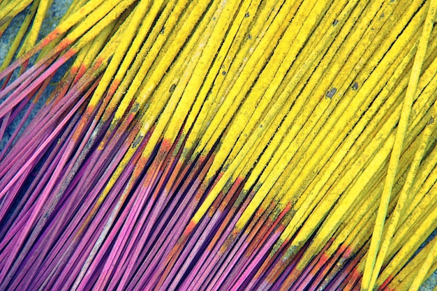 A detailed section of a graffiti mural featuring vibrant yellow and deep purple elements, showcasing fine lines and dynamic shapes in an abstract style.