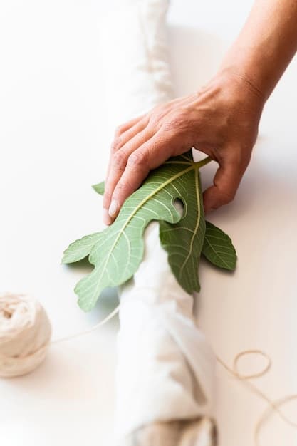 A close-up of a hand feeling a swatch of organic cotton fabric, with a blurred background of sustainable clothing racks in a boutique.